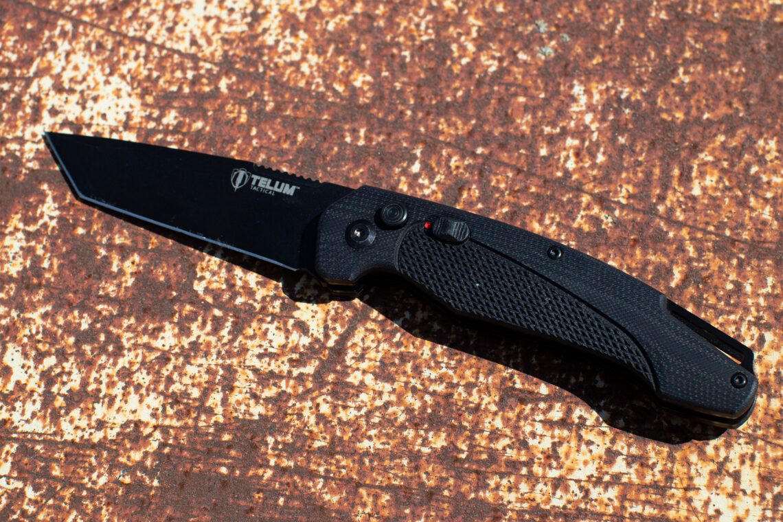 Telum Tactical Black Titan Knife Product over textured background